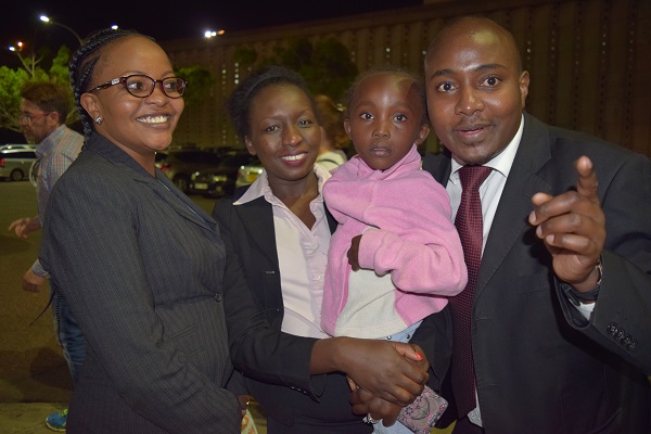 Diaspora Banking staff Shellmith Gichuki, Grace Mwangi and Sammy Kimani with one of the girls at the airport.