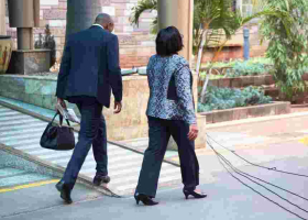 Kenyans Online React to Photo of Gender CS Sicily Kariuki's Bodyguard Carrying Her Handbag