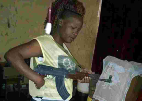 Photos of Gun-Wielding Kenyan Woman Go Viral Online, Kenyans Call for Her Arrest