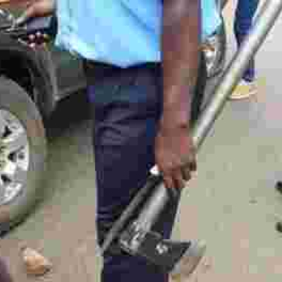 Kenyan Policeman Pictured Handling Murder Weapons with Bare Hands, Kenyans React