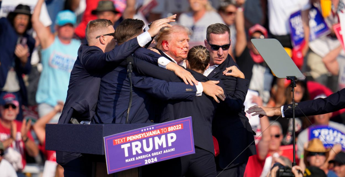 Shooter and Bystander Dead, Trump 'Fine' After Gunfire Erupts at Rally Bloodied Trump Evacuated as Gunfire Erupts at Pennsylvania Rally