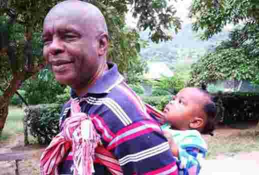 Photo of Makueni Governor Prof Kivutha Kibwana Carrying Child on His Back Goes Viral Online